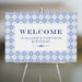 Elegant Mediterranean blue tile welcome sign with navy text on an easel, personalized for birthdays, weddings, or milestone events.