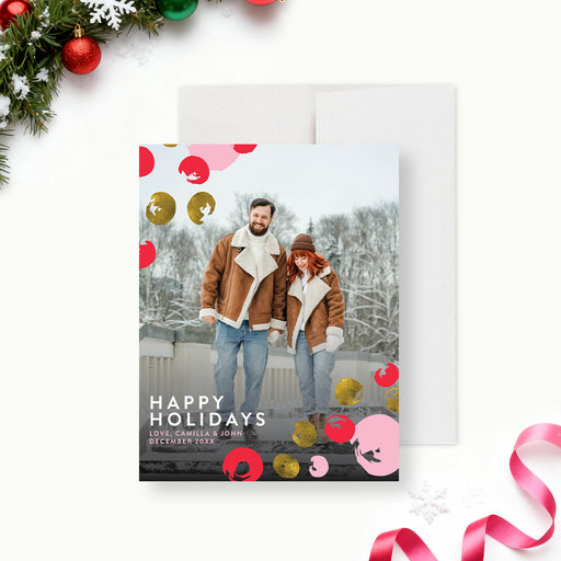 modern holiday photo greeting card featuring winter couple portrait with pink red and gold festive accents-front