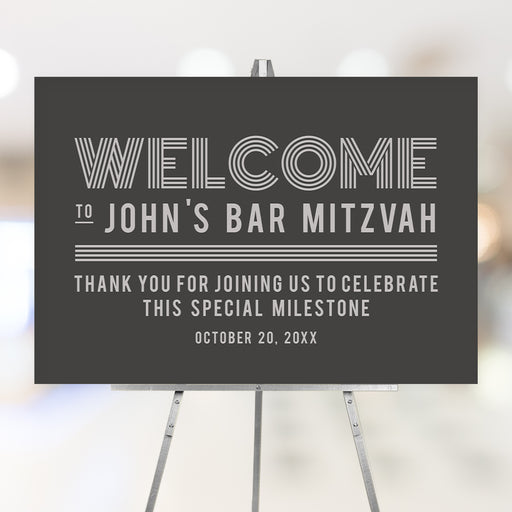 Modern personalized Bar Mitzvah welcome sign with gray background, custom name and event date displayed on an easel