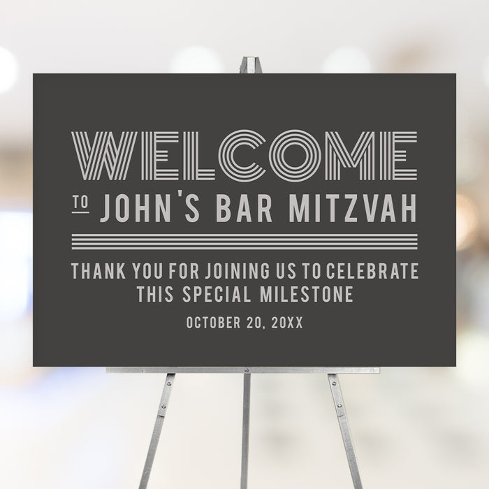 Modern personalized Bar Mitzvah welcome sign with gray background, custom name and event date displayed on an easel