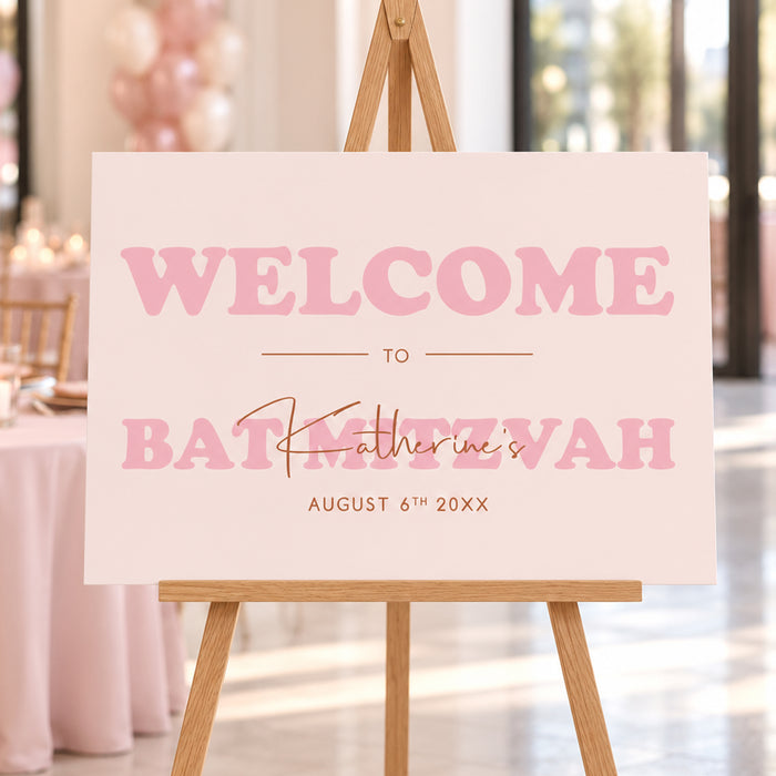 Blush pink Bat Mitzvah welcome sign, displayed on an easel for a girl’s milestone celebration.