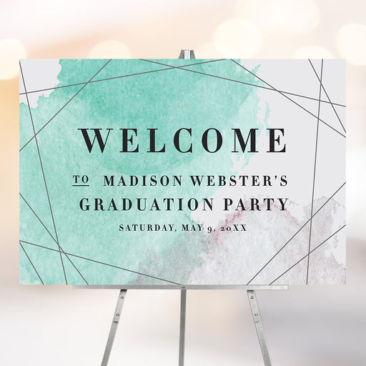 graduation welcome sign with teal blush watercolor background, modern geometric lines details, and custom graduate name displayed on an easel.