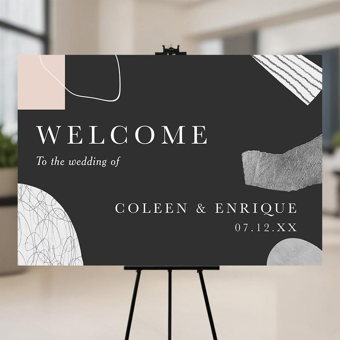 Modern abstract wedding welcome sign with black background and minimalist shapes displayed on easel.