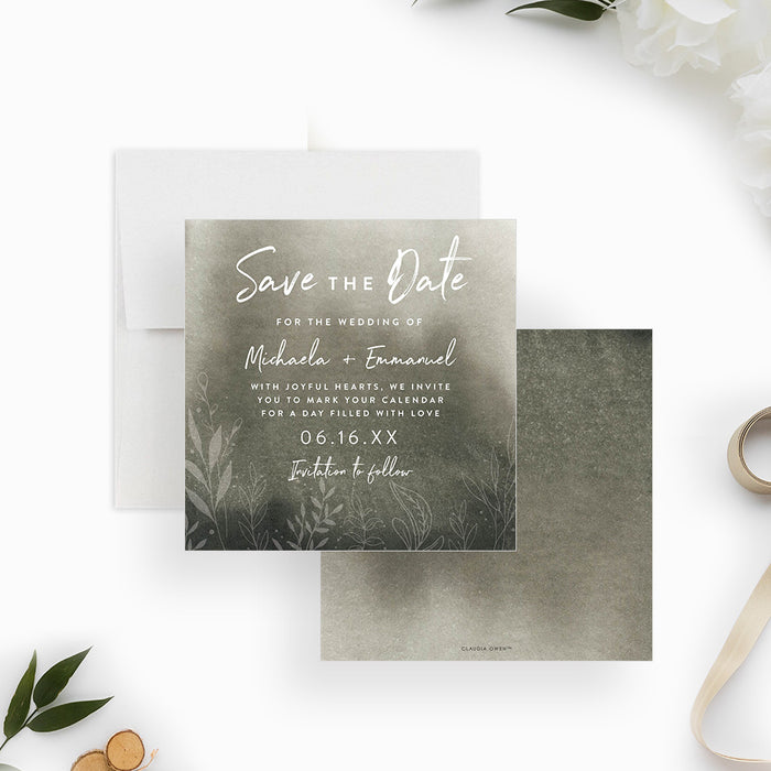moody green botanical wedding save the date card with soft watercolor background, white lettering, and delicate foliage details-front-back