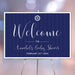 nautical baby shower welcome sign with navy blue background, ship wheel emblem, and personalized event wording