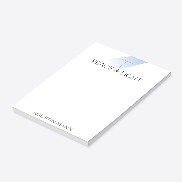 personalized First Holy Communion notepad with Peace & Light wording, cross symbol, custom name, and clean white writing space-side