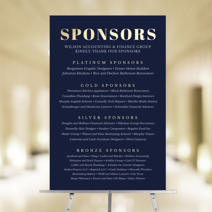Navy blue Sponsors poster on an easel with gold heading and tiered sponsor acknowledgments.