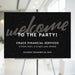 New Year party welcome sign with elegant black background and modern lettering displayed on easel for holiday event entrance decor