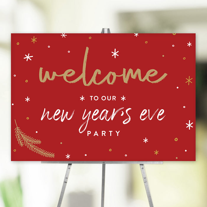 Red New Year’s Eve party welcome sign with gold and white lettering, festive stars, and pine branch accents, ideal decor for holiday celebrations.