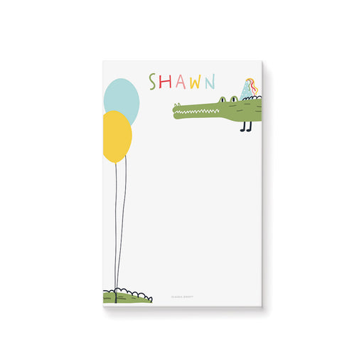 Personalized kids notepad with a cute alligator in a party hat, colorful balloons, and custom name on a playful birthday-themed design.