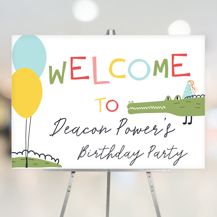 Kids birthday welcome sign with colorful lettering, cute alligator in a party hat, and balloons on a playful gator party design.