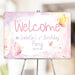 Personalized birthday party welcome sign with soft pastel watercolor butterflies for a girl’s first birthday party