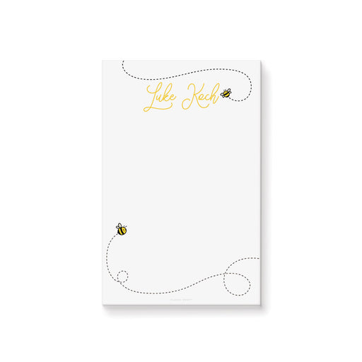 Personalized honey bee notepad with cute bee illustrations, dotted flight paths, and custom name in yellow script on a clean white background