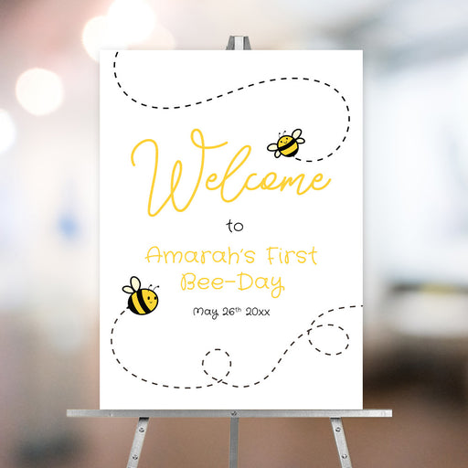 Honey bee birthday welcome sign with cute bee illustrations, dotted flight paths, and yellow script text for a first birthday party.