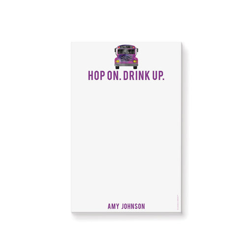 Personalized notepad featuring a watercolor party bus illustration and the “Hop On. Drink Up.” tagline