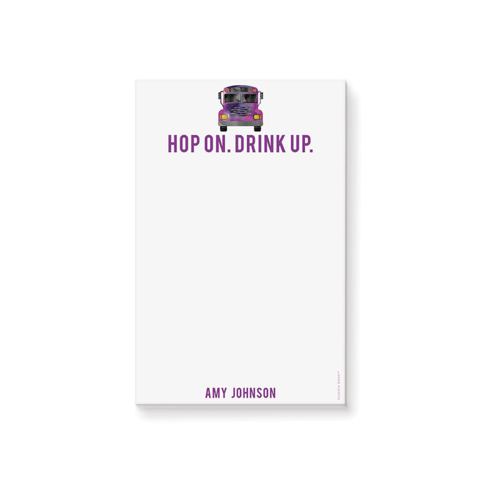 Personalized notepad featuring a watercolor party bus illustration and the “Hop On. Drink Up.” tagline