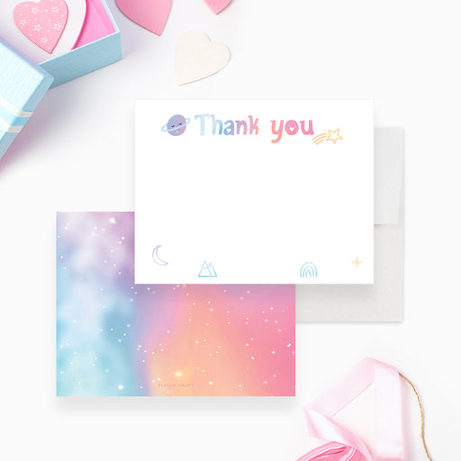 Pastel thank you note card with small planets, stars and a crescent moon and a colorful celestial reverse.