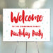 Festive red and white welcome sign for a Pawliday party, personalized with the family name and decorated with light blue snowflakes.