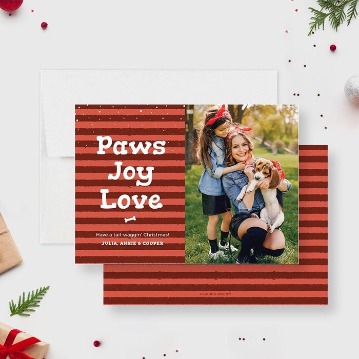 red striped holiday card reading paws joy love and a photo section showing people outdoors with a dog