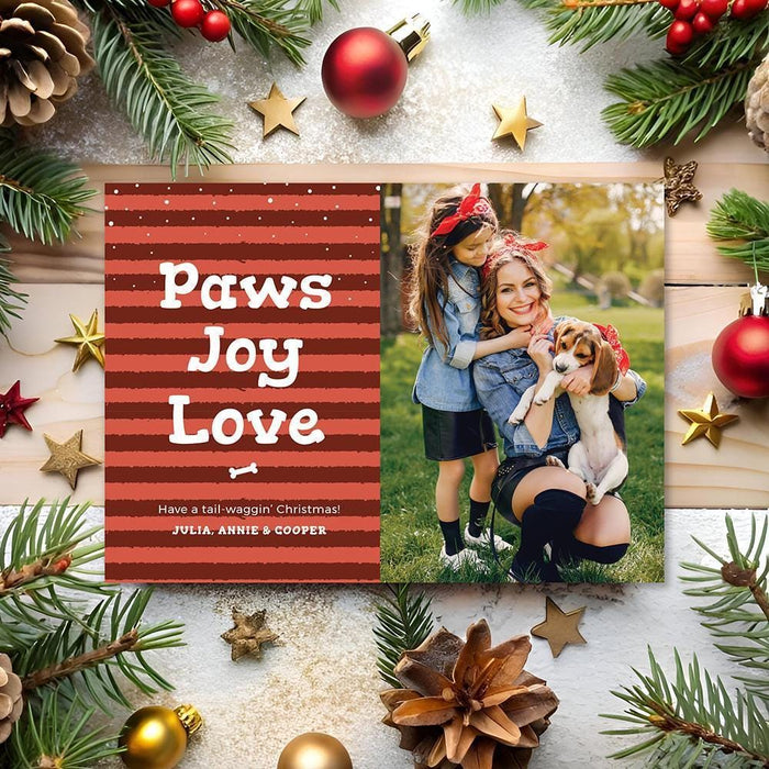 red striped holiday card reading paws joy love and a photo section showing people outdoors with a dog