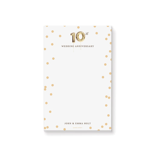 Personalized notepad with gold confetti dots, gold balloon 10th anniversary design, and custom names at the bottom
