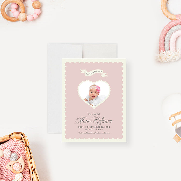 Blush pink baby announcement card with a heart-shaped photo cutout, personalized with the baby’s name and birth details.-front