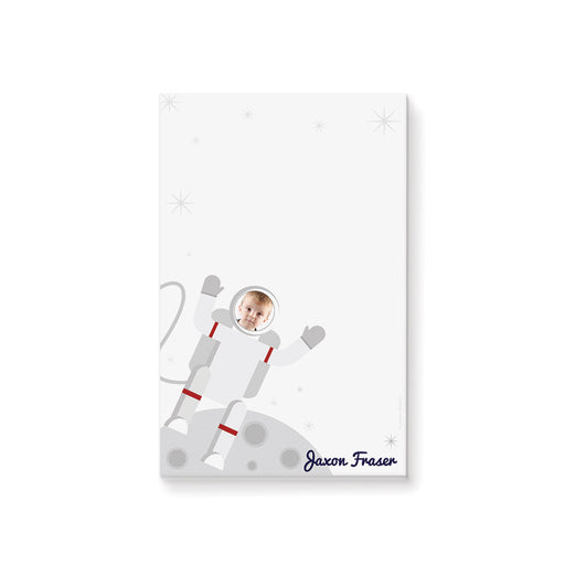 Personalized astronaut photo notepad for kids with child’s face in an illustrated spacesuit, custom name, moon landscape and blank writing area
