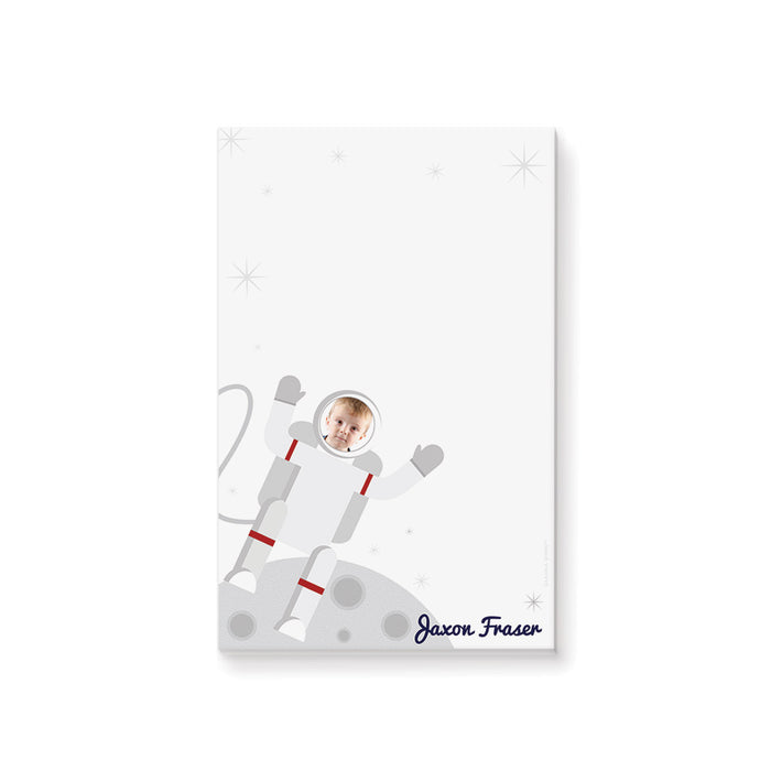 Personalized astronaut photo notepad for kids with child’s face in an illustrated spacesuit, custom name, moon landscape and blank writing area