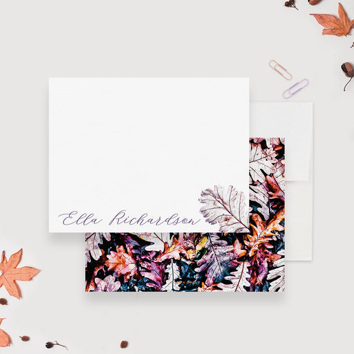 Personalized autumn note cards with a leaf illustration beside the name on the white front and colorful fall leaves on the dark reverse.