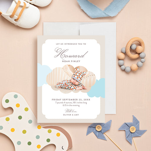Personalized neutral beige and light blue cloud baby boy birth announcement card with newborn photo, name, birth date, weight, length, arrival time, and parents' names-front