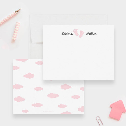 Personalized baby note cards with pink footprints between the first and last name on white and a pink cloud pattern on the back.