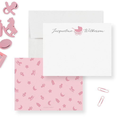 Personalized baby note cards with a pink vintage stroller and name on white; pink back patterned with moons, stars and baby motifs.