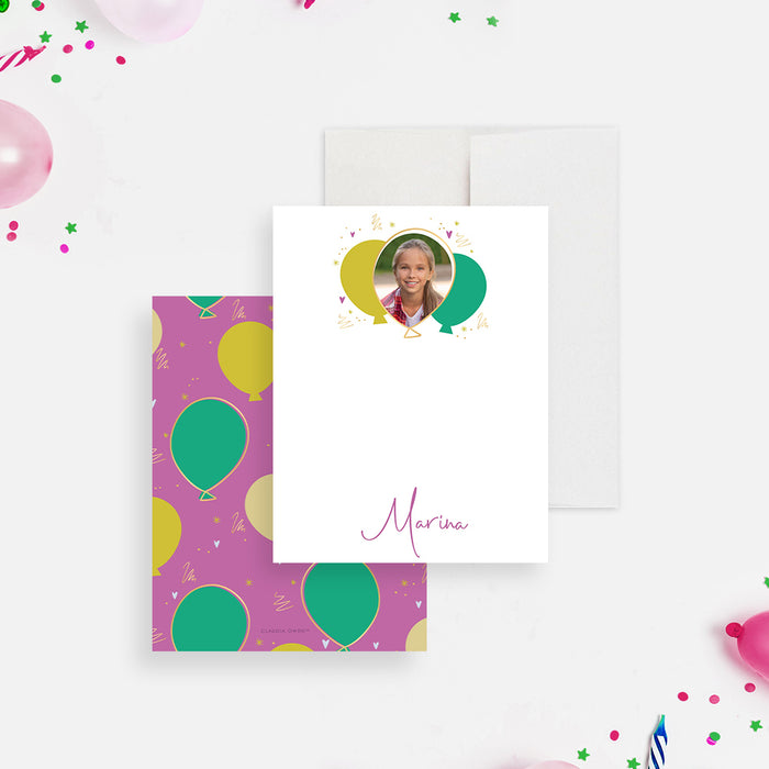 White personalized birthday note card with a child's photo inside a colorful balloon design and a script name below.