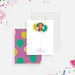 White personalized birthday note card with a child's photo inside a colorful balloon design and a script name below.