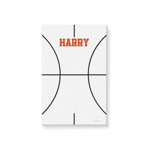 Personalized basketball notepad featuring a white basketball-textured background and a custom name in bold orange lettering.