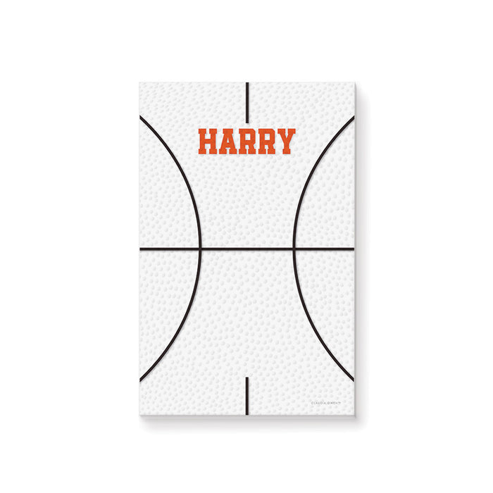 Personalized basketball notepad featuring a white basketball-textured background and a custom name in bold orange lettering.