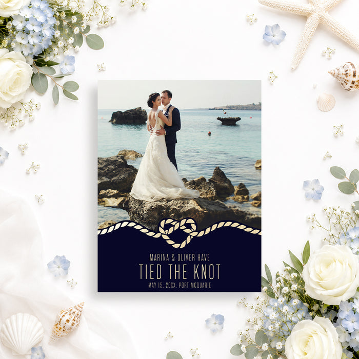 Personalized wedding announcement card with a couple’s photo, rope heart detail, and navy blue background