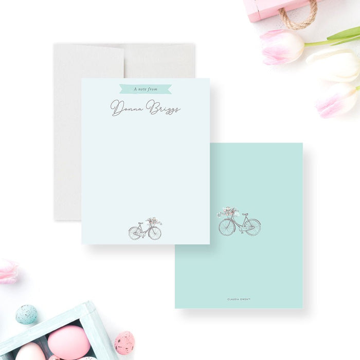 Personalized Bicycle Note Card with Flowers. Front and matching aqua back with a matching bicycle illustration displayed with a white envelope.