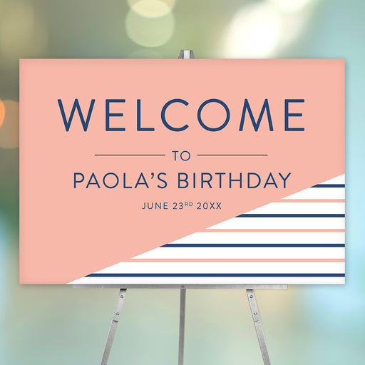 Personalized birthday party welcome sign with peach background, navy blue and peach stripes, honoree’s name and celebration date