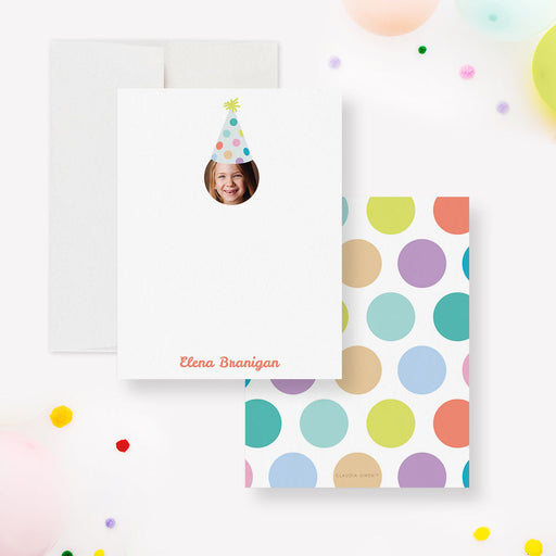 Front and back of personalized note cards with a child's portrait in a party hat and a personalized name and a colorful polka dot patterned back.