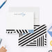 Personalized note cards with black and white geometric stripes, blue accent bars and a custom name on the front.