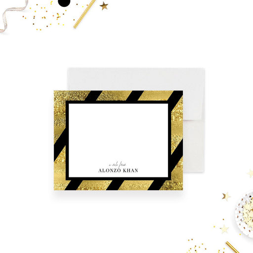 Personalized note card with a white writing area framed by black and printed gold diagonal stripes with a name at the bottom. Shown with a white envelope.