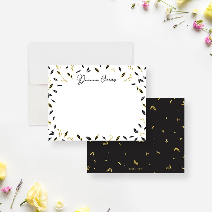 Personalized Black and Gold Leaf Note Cards. Front and matching black back with small printed gold leaf illustrations displayed with a white envelope.
