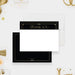 White thank you note card with a black header and gold-colored border, beside a black back framed with a fine gold-colored line.
