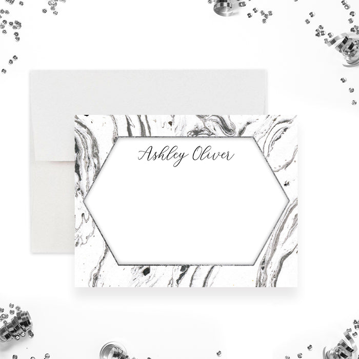 Personalized note card with a black and white marble front with a white hexagonal writing area and a name in script. Shown with a white envelope.