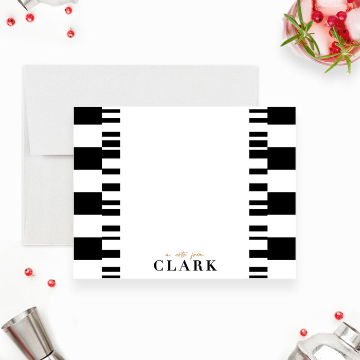 Personalized note card with a white writing area with a bold black and white striped border and personalized name. Shown with a white envelope.