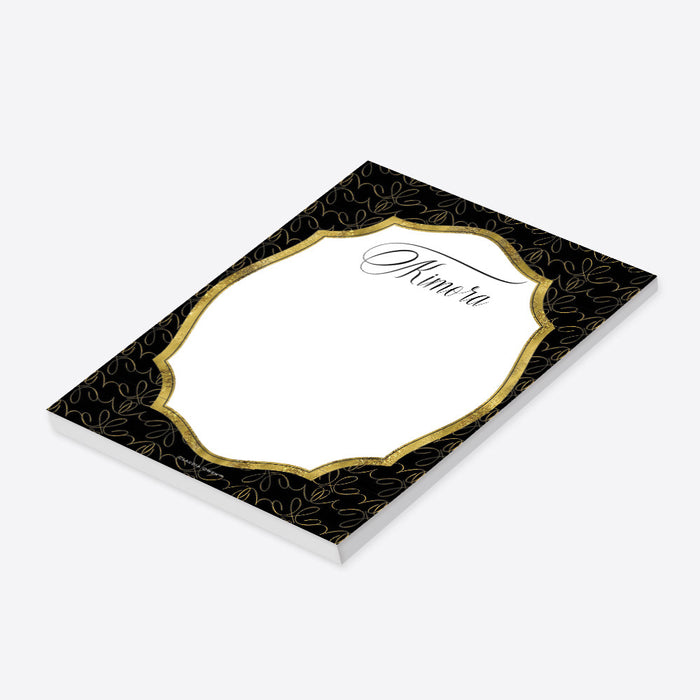 Personalized black and gold business notepad with an ornate patterned border, white writing area, and name in elegant script lettering-side
