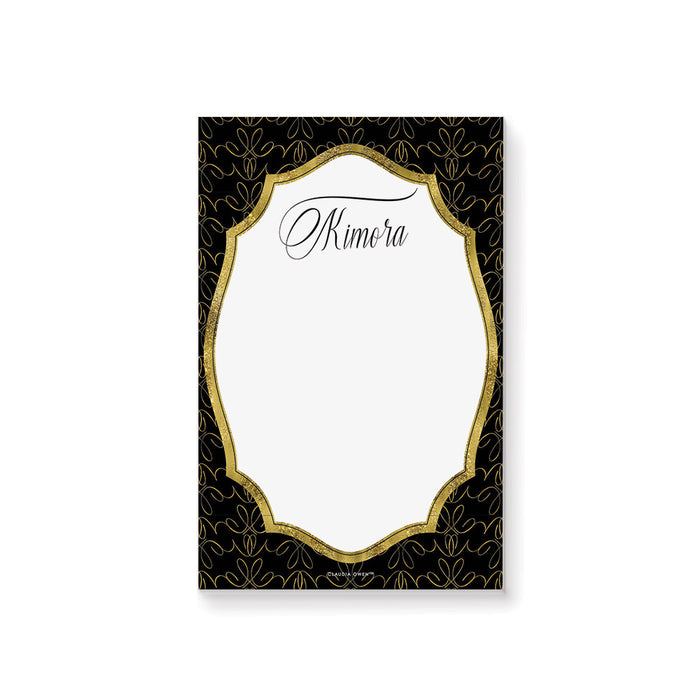 Personalized black and gold business notepad with an ornate patterned border, white writing area, and name in elegant script lettering