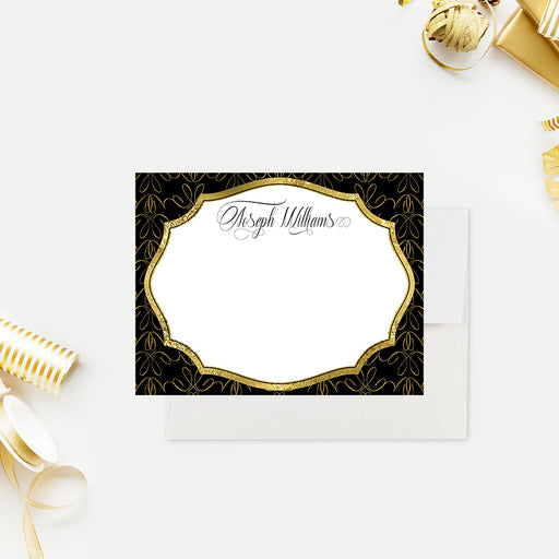 Personalized black and gold note card shown with a script name, ornate gold frame, looping patterned border, and blank white writing area-front