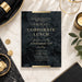 Black marble corporate lunch invitation with gold lettering and a white envelope-front